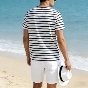 Back view of a man wearing a black and white striped breathable T-shirt on a beach