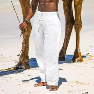 Men's breathable white cotton linen wide-leg casual pants with drawstring waist shown in beach scene
