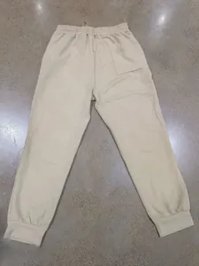 Detailed view of beige men's casual joggers featuring unique jacquard textured fabric