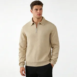 Macro detail showing the geometric jacquard texture of this beige men's long sleeve polo