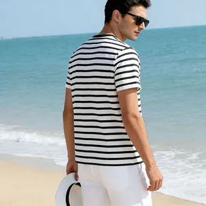Rear view of a man wearing a classic black and white striped short-sleeve T-shirt on a beach.