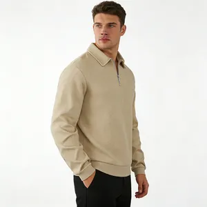 Detail of beige men's long sleeve polo shirt with unique jacquard texture and zip