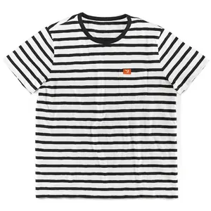 Close-up of black and white striped men's T-shirt featuring a small pocket with orange tag