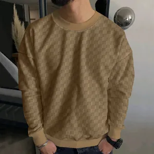 Detail showing the heavy jacquard checkerboard texture of this men's khaki knit sweater.