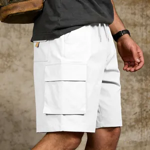 Detail of white men's cargo shorts with functional side pockets and drawstring waist.