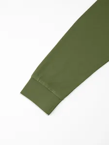 Close-up of olive green long sleeve polo shirt ribbed cuff with white edge detail
