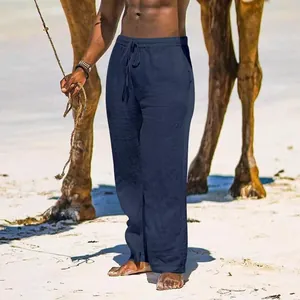 Men's breathable cotton linen wide-leg trousers shown in a sunny beach holiday setting
