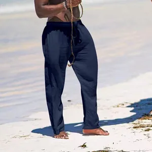 Men's comfortable loose navy blue cotton linen wide leg trousers shown on beach