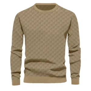 Close-up of heavy jacquard checkerboard pattern on men's khaki crewneck knit sweater.