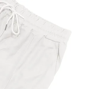 Close-up of white waffle knit shorts showing drawstring waistband and side pocket details