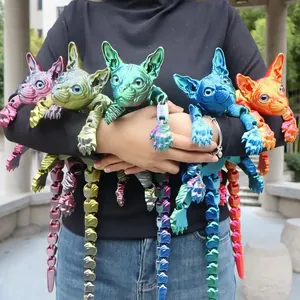 Variety of colorful 3D printed articulated Sphynx cat figures held in hands.