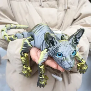Detailed macro view of an articulated 3D printed gray Sphynx cat figurine held in hands