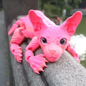 Detailed shot of a pink 3D printed articulated hairless cat figure on a stone ledge