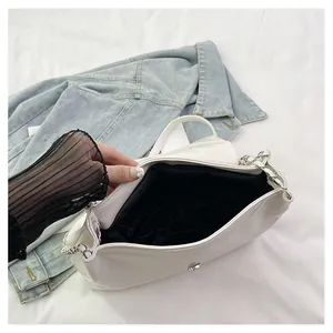 Close-up interior view showing the spacious black fabric lining of this white shoulder bag