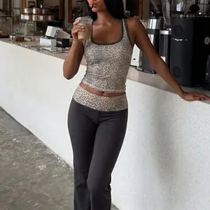 Leopard print tank top and grey flared leggings set worn in a stylish cafe lifestyle setting