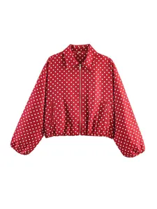 Close-up view of red retro polka dot jacket featuring a zipper and classic collar