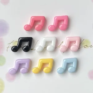 Close-up of colorful glossy music note resin charms for DIY crafts and accessories