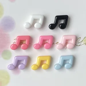 Detail showing a variety of colorful glossy musical note resin flatback charms for DIY crafts