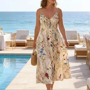 Elegant floral maxi dress with spaghetti straps shown at a sunny seaside resort