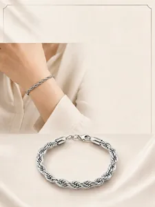 Close-up detail of silver rope chain bracelet featuring a secure lobster clasp.