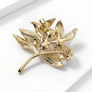 Detailed back view of a gold branch brooch with pearls showing the pin mechanism