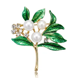 Elegant gold-tone tree branch brooch with white pearls and green enamel leaves