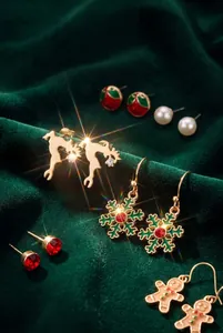 Close-up of Christmas earring set with snowflake and reindeer details