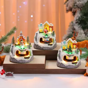 Three different designs of Christmas rotating music boxes with miniature train sets