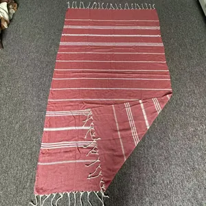 Terracotta Turkish cotton beach towel with white horizontal stripes and hand-knotted fringe.