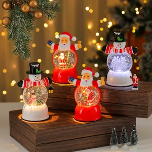 Festive set of assorted Santa Claus and snowman light-up resin musical snow globes