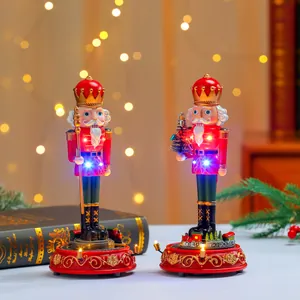 Detailed view of two Christmas nutcracker music boxes with rotating trains and LED lights