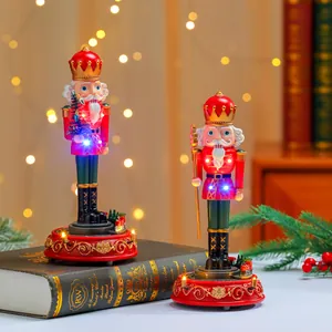 Detailed view of two illuminated Christmas nutcracker music boxes with rotating trains