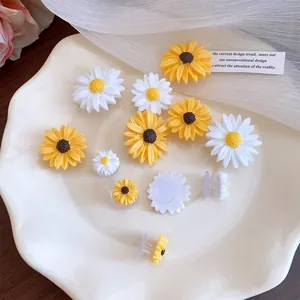 Detailed close-up view of cute resin sunflower and daisy shoe charms for clog decorations.
