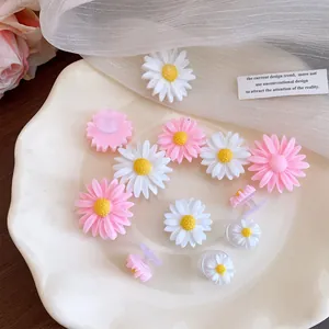Detailed view of colorful resin daisy charms for clogs and DIY shoe decoration