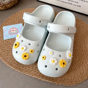 Close-up of cute resin daisy flower charms attached to light blue clog shoes style