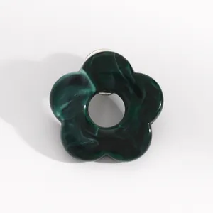 Detailed view of the dark green marbled resin hollow flower glasses holder brooch