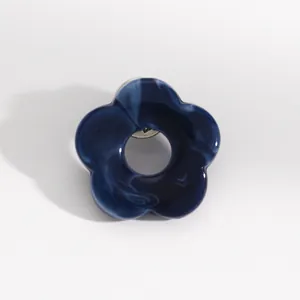 Blue marble pattern hollow flower brooch pin with center hole used as eyeglass holder