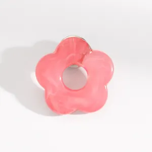 Close-up detail view of a pink marble-textured hollow flower glasses holder brooch pin.