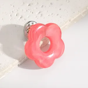 Detail shot of a pink resin hollow flower brooch designed for holding eyeglasses