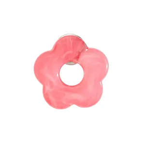 Close-up detail of a pink marbled resin flower brooch used as a stylish glasses holder pin