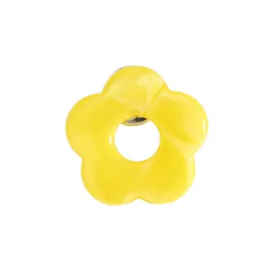 Detailed close-up of a vibrant yellow hollow flower eyewear brooch for suit lapels