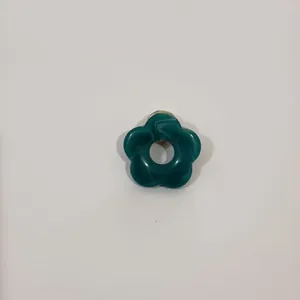 Macro view of a dark green hollow flower brooch designed for holding glasses securely.