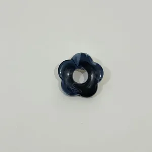 Detailed close-up of a marbled blue hollow flower brooch used as a stylish glasses holder