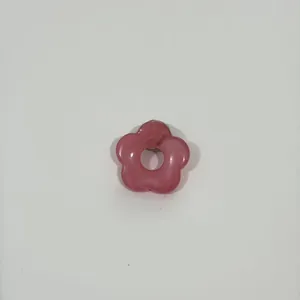 Close-up detail of a pink hollow flower glasses brooch for holding eyewear on clothes