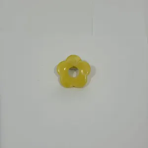Close-up of a yellow hollow flower-shaped eyeglass brooch pin