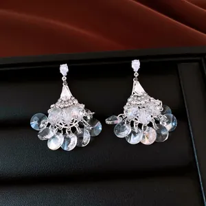 Detailed close-up of vintage fan-shaped chandelier earrings with sparkling crystals