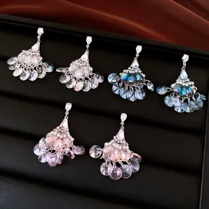 Close-up showing vintage fan-shaped tassel earrings with colorful crystal rhinestones