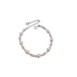 Elegante bracciale con perle rosa e sfere di zirconi con ciondolo a forma di cuore