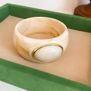 Vintage marble acrylic wide bangle with gold-rimmed oval inset detail