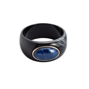 Vintage wide black acrylic bangle with a marbled pattern and blue oval centerpiece inlay